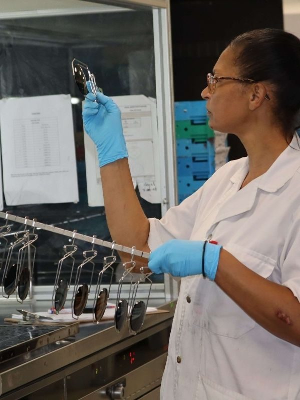 A member of our lens lab team checking lenses
